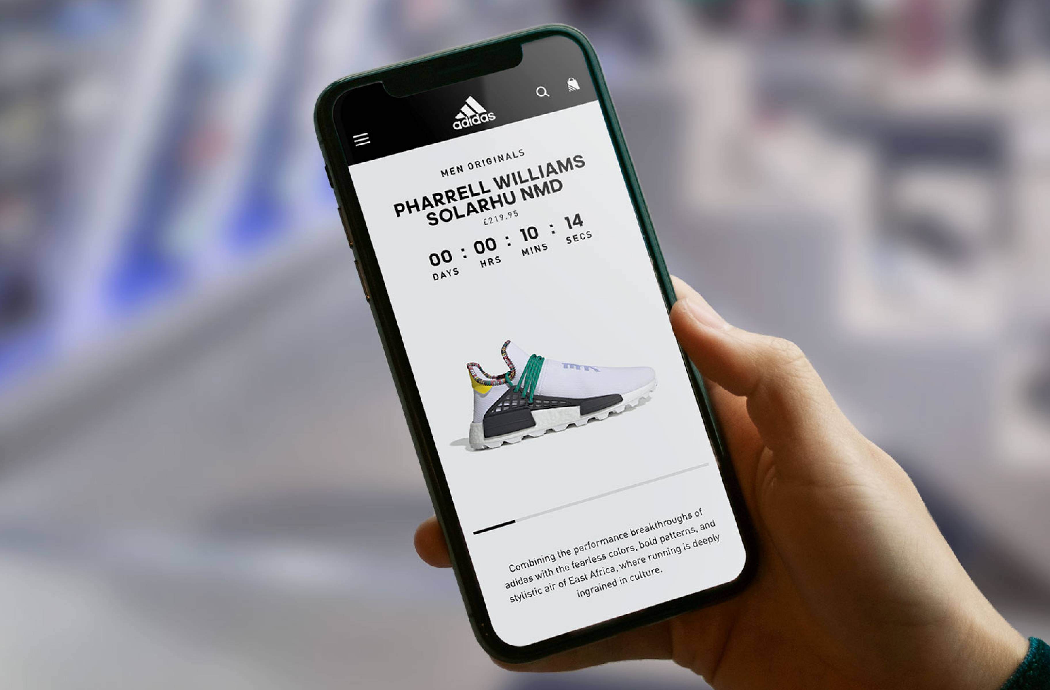 Hand holding phone with adidas app