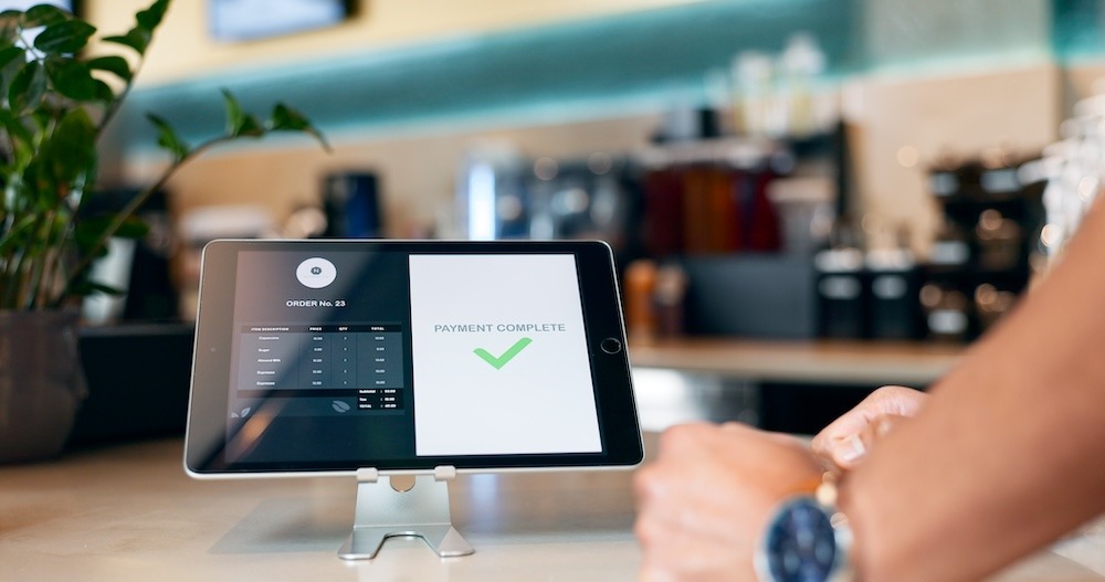 A tablet on a counter displaying a successful payment message.