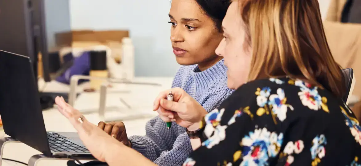 Two people looking at a screen