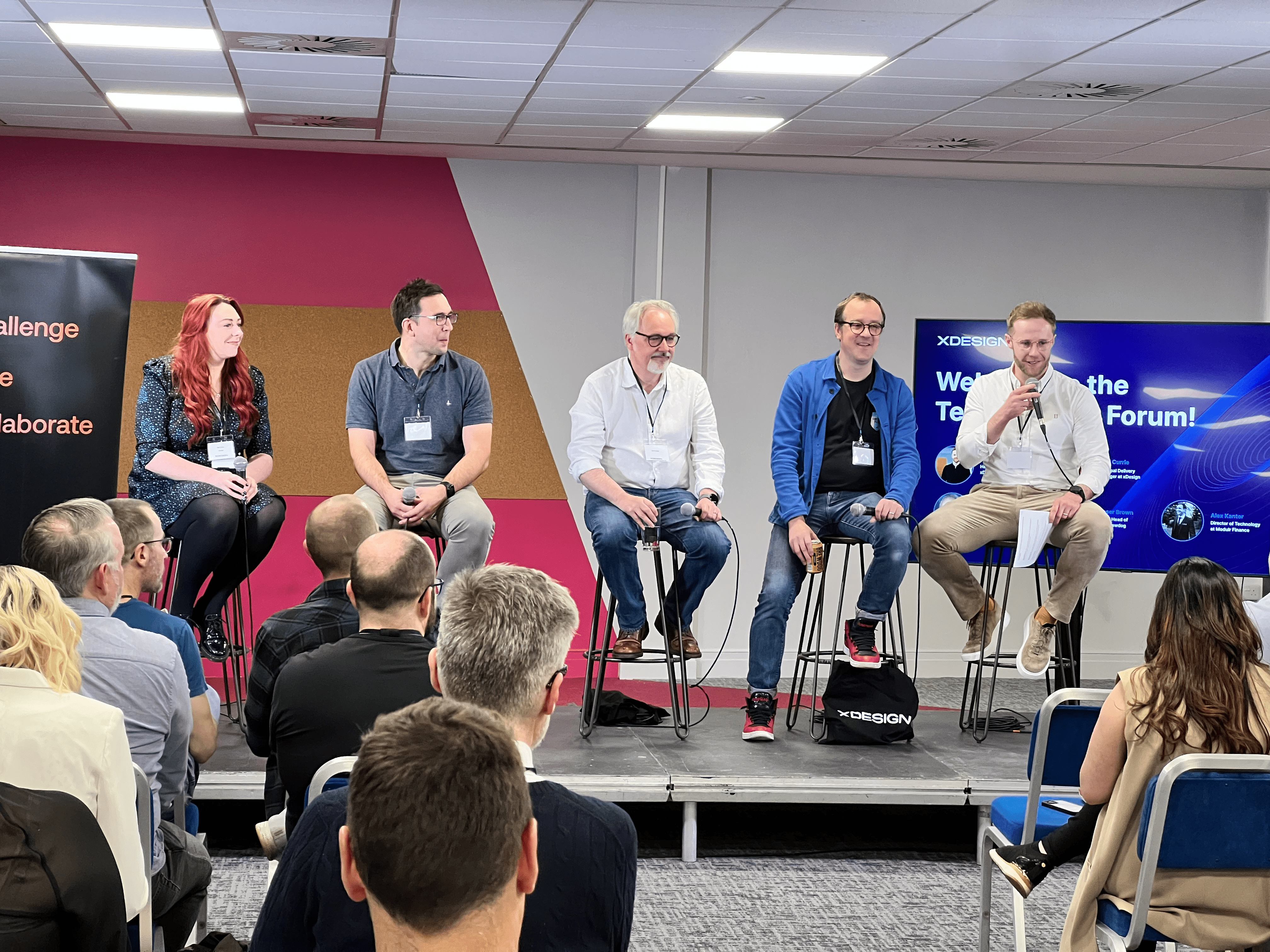 Five people on a panel on stage